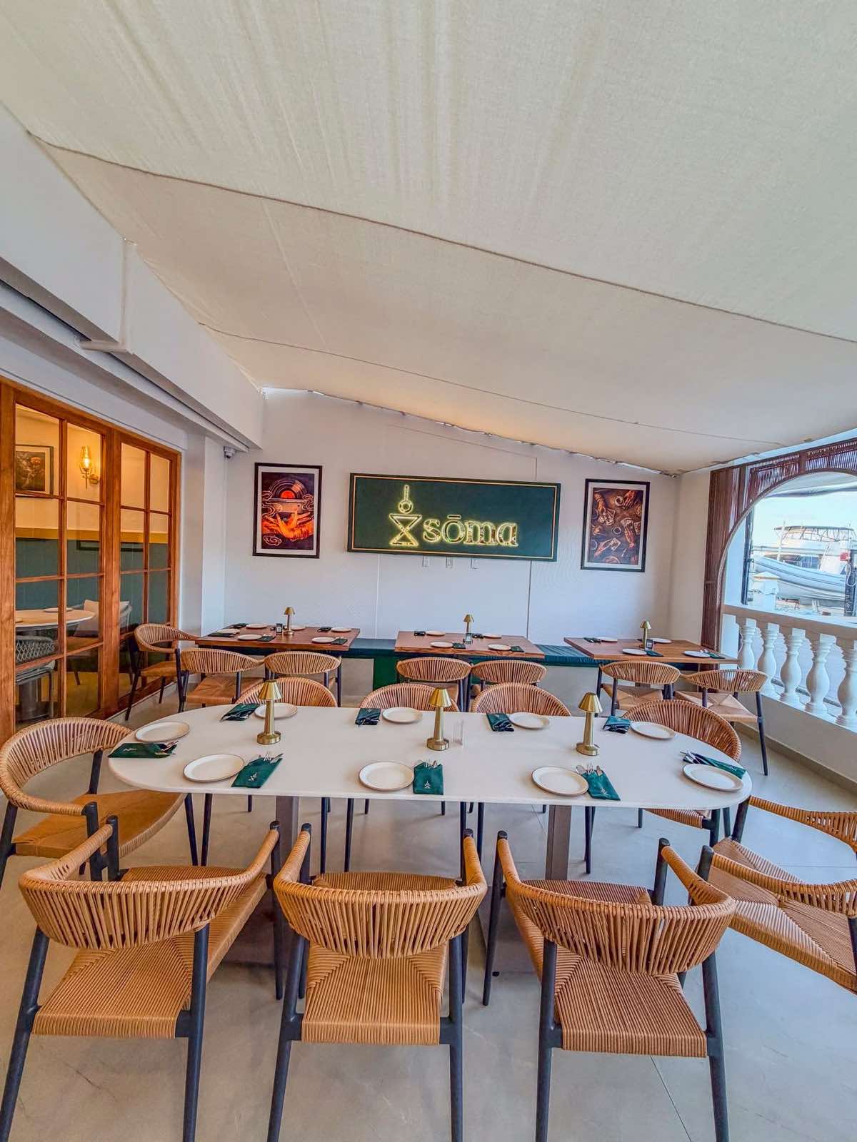 The Sōma dining room, with the neon sign on the back wall